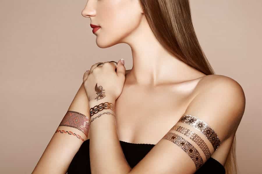woman with metallic tattoos on her arms
