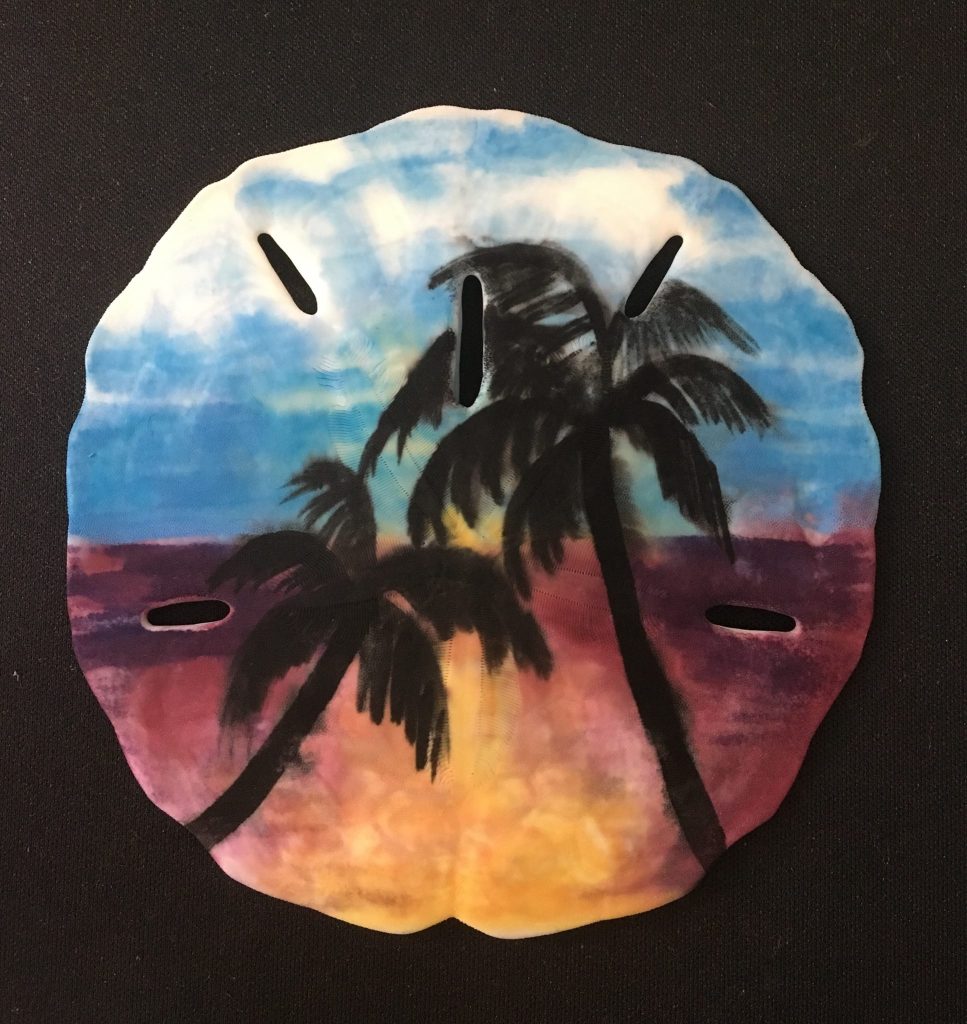 sand dollar painted with palm trees