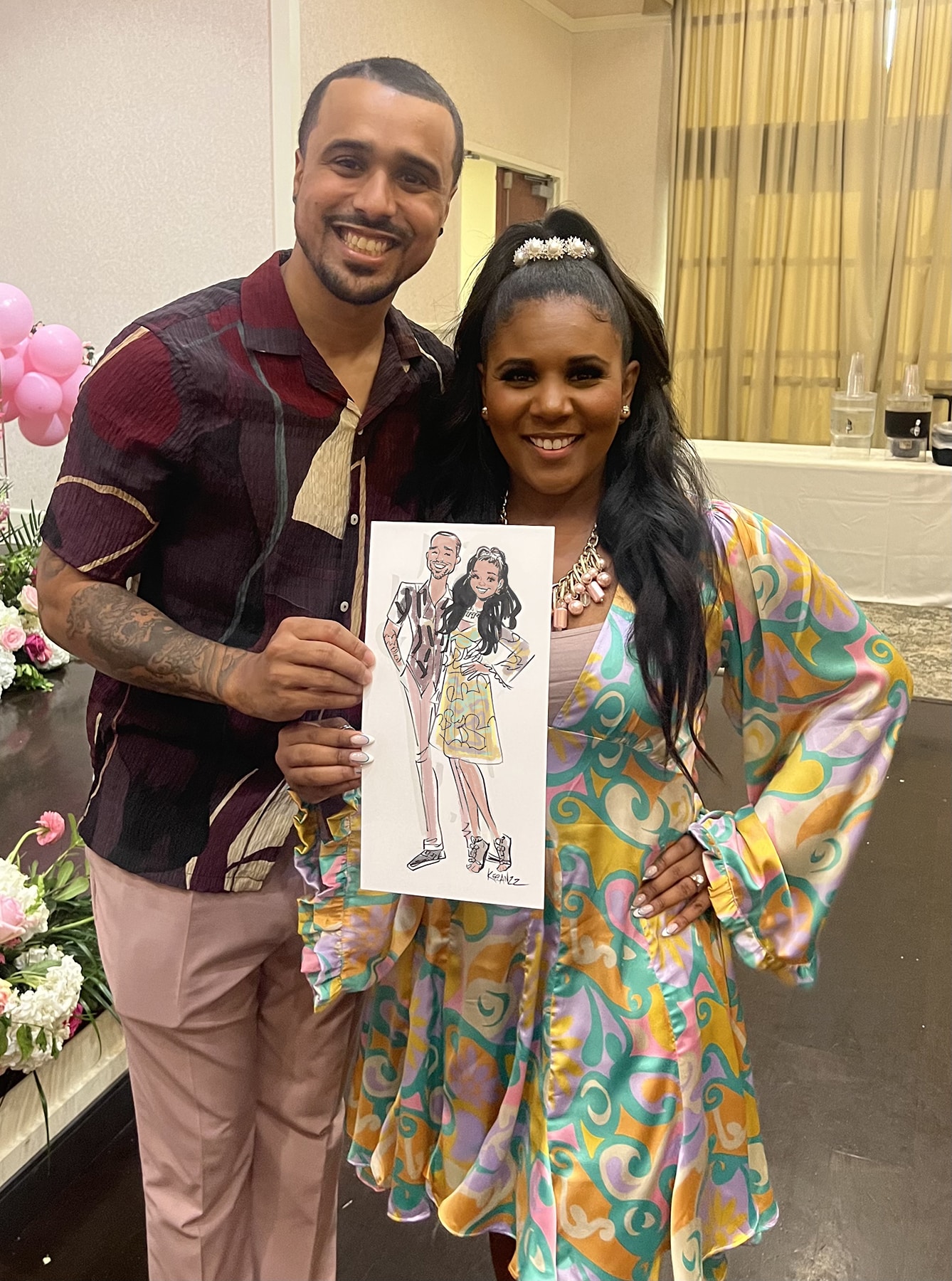 Couple holding a Fashion Sketch of themselves