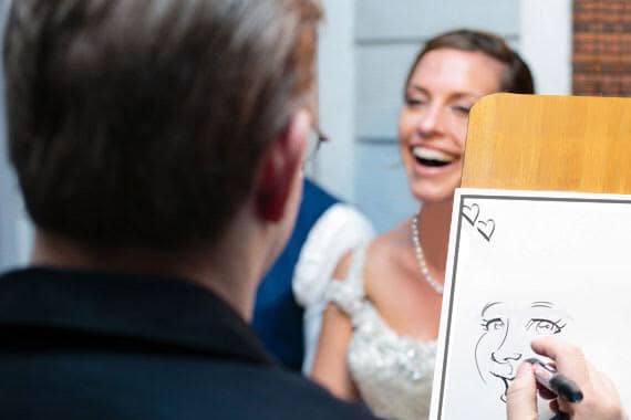 Bride smiling while being sketched by a caricaturist