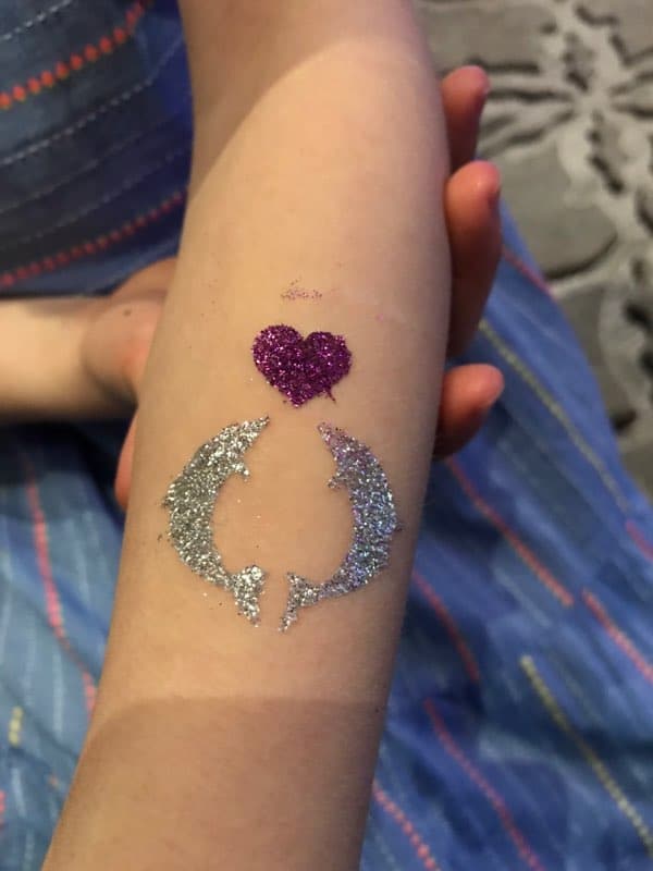 glitter tattoo of dolphins and a heart