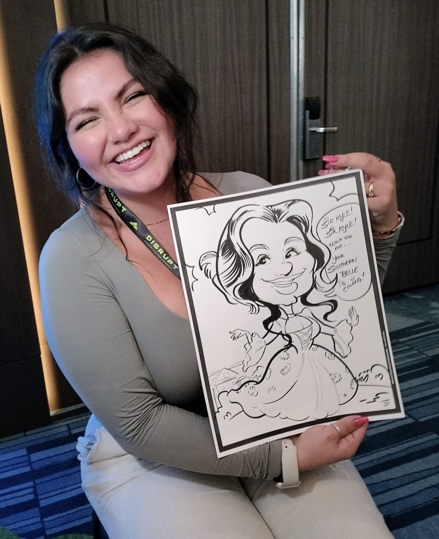 woman holding caricature drawing of herself