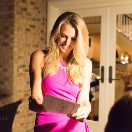 Woman holding her artwork and smiling