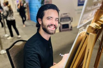 ATG artist sketching at an event