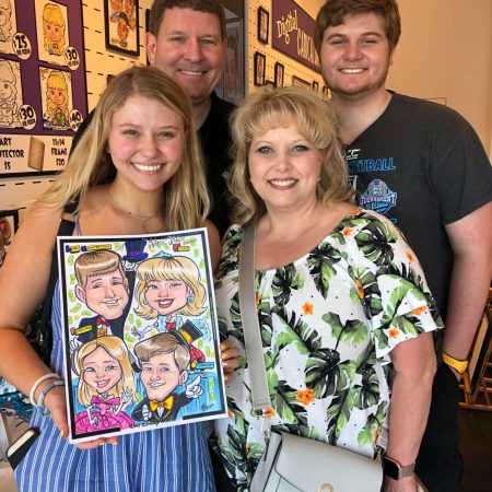 family standing with their caricature from the art corner at disney springs