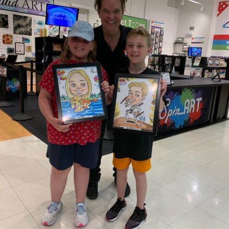 artist with two kids and their caricatures